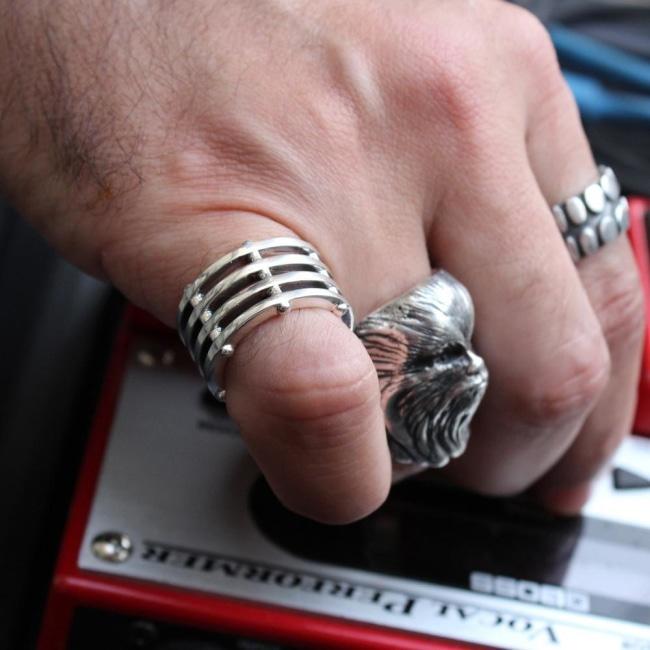 shot of a man wearing the grill ring and a chewbacca ring playing music