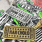shot of the drink ticket pendant in gold and silver on the hc roses graphic t shirt