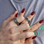 shot of a man and woman holding hands wearing the till death do us part rings