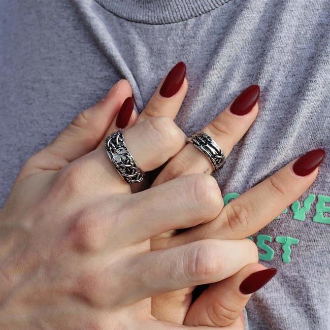 shot of a man and woman holding hands wearing the till death do us part rings