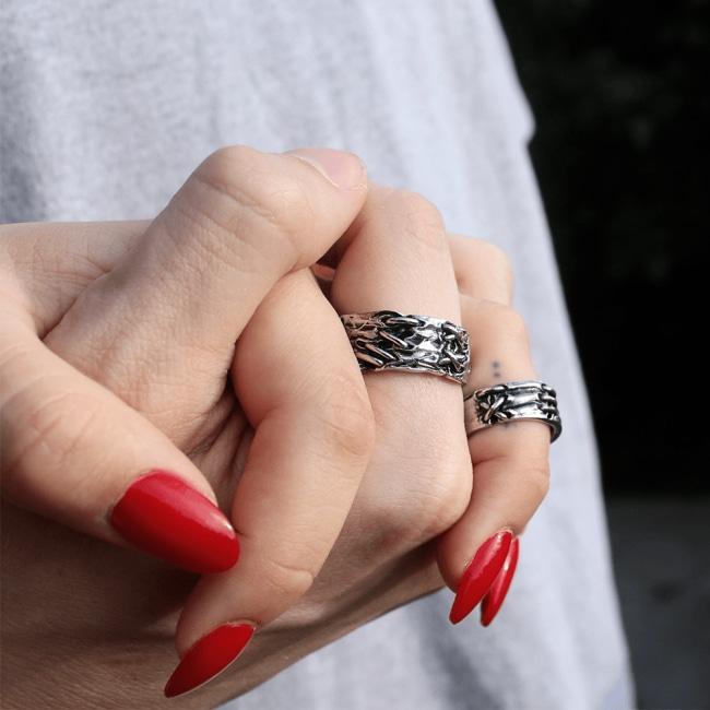 shot of a man and woman holding hands wearing the till death do us part rings