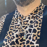 unlucky cat pendant on leopard shirt silver and gold