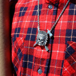 shot of the Indian Chief Necklace in silver from the han cholo skulls collection on a man in red