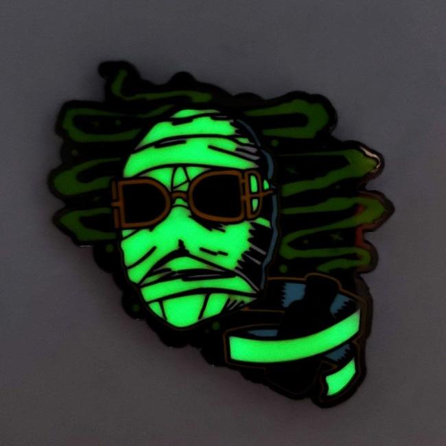 glow in the dark shot of the Invisible Man Enamel Pin from the Universal Monsters jewelry collection