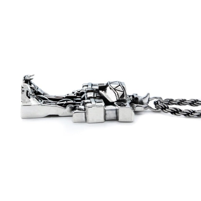 side view of the megazord pendant from the mighty morphin power rangers on a white background