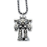 silver megazord pendant from the mighty morphin power rangers laying flat on a white background