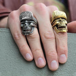 shot of a man wearing the loco skull ring in gold and one in silver