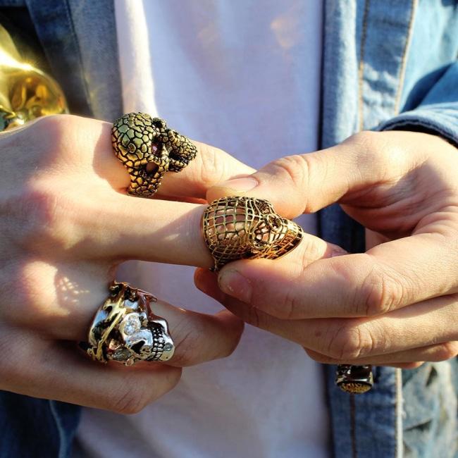 shot of a man wearing the Mesh Skull Ring in gold from the han cholo skulls collection