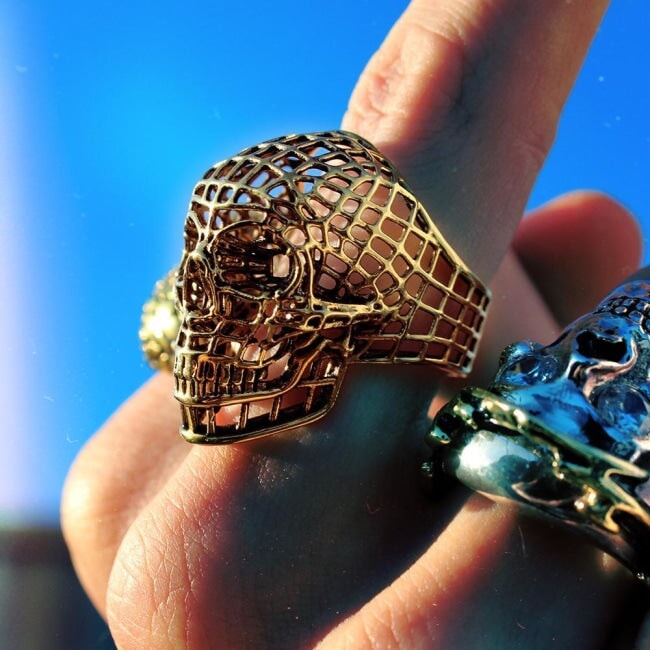 shot of a man wearing the Mesh Skull Ring in gold from the han cholo skulls collection
