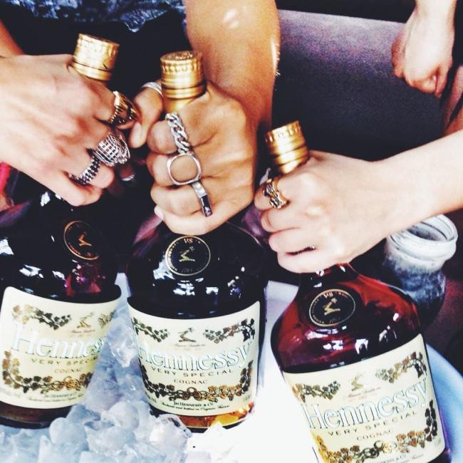 shot of people partying with hennessy bottle wearing the open space ring
