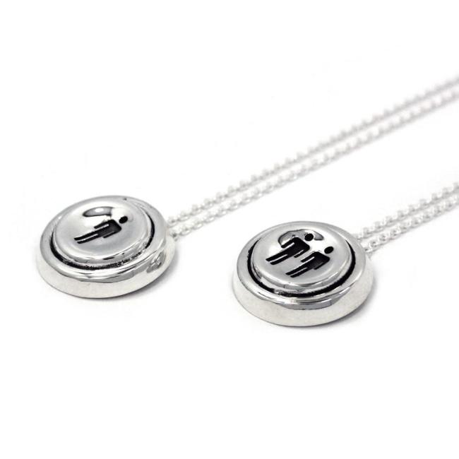 right angle view of the Player 1 player 2 necklaces on a white background