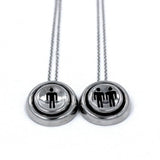 up close view of the Player 1 player 2 necklaces on a white background