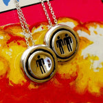 shot of the Player 1 Player 2 necklaces on a colorful background