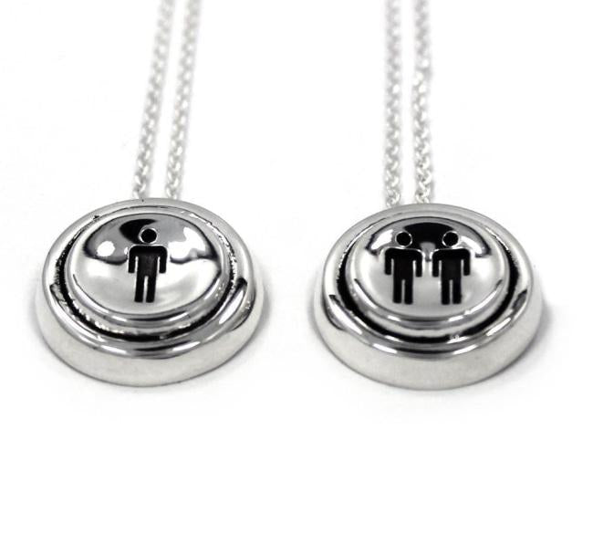 up close view of the Player 1 player 2 necklaces on a white background