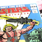 shot of the power sword pin on a masters of the universe comic book