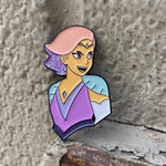 shot of the queen glimmer enamel pin leaning on a concrete wall