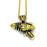 right side shot of the Ray Gun Pendant in gold on a white surface