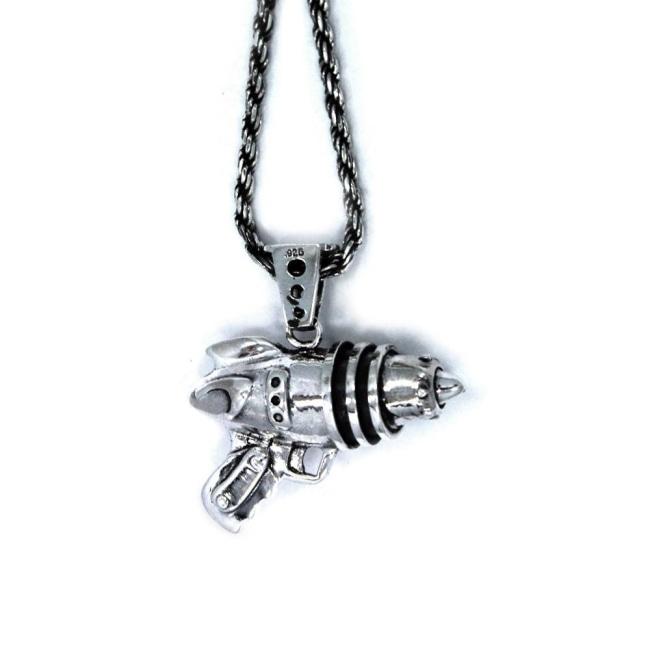 left side shot of the Ray Gun Pendant in silver on a white surface