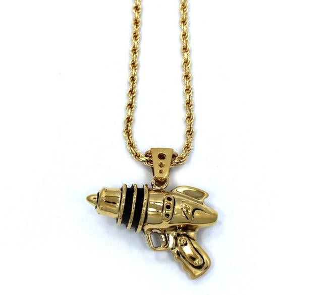 right side shot of the Ray Gun Pendant in gold on a white surface