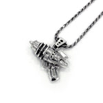 right angled shot of the Ray Gun Pendant in silver on a white surface