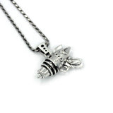 left angled shot of the Ray Gun Pendant in gold on a white surface