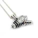 right angled shot of the Ray Gun Pendant in silver on a white surface
