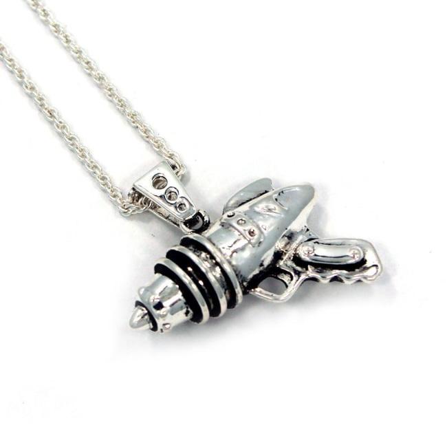 right angled shot of the Ray Gun Pendant in silver on a white surface