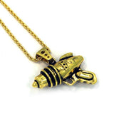 right angled shot of the Ray Gun Pendant in gold on a white surface