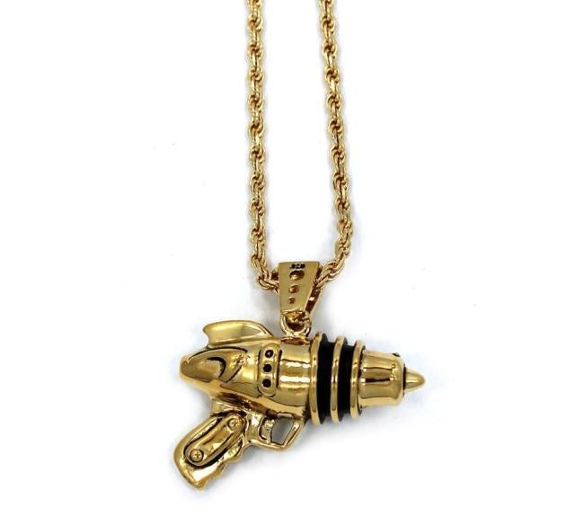 left side shot of the Ray Gun Pendant in gold on a white surface