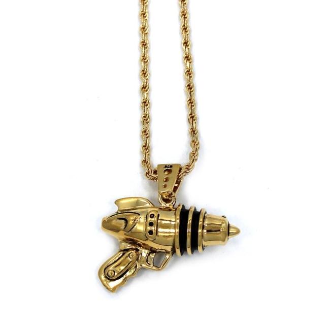 left side shot of the Ray Gun Pendant in gold on a white surface
