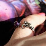shot of a girl wearing the Skeletor havoc Ring in silver with a masters of the universe book