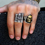 shot of the skeletor and castle grayskull ring on a mans hand holding a black brick