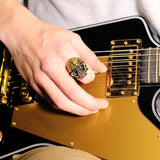 shot of a man playing guitar and wearing the Skull Ring in gold from the fantasy collection