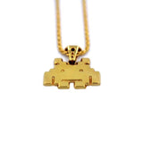 up close view of the smiley invader pendant in gold on a white background