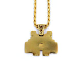 back view of the smiley invader pendant in gold on a white background