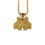 front view of the smiley invader pendant in gold on a white background