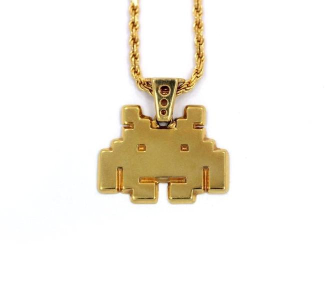 front view of the smiley invader pendant in gold on a white background