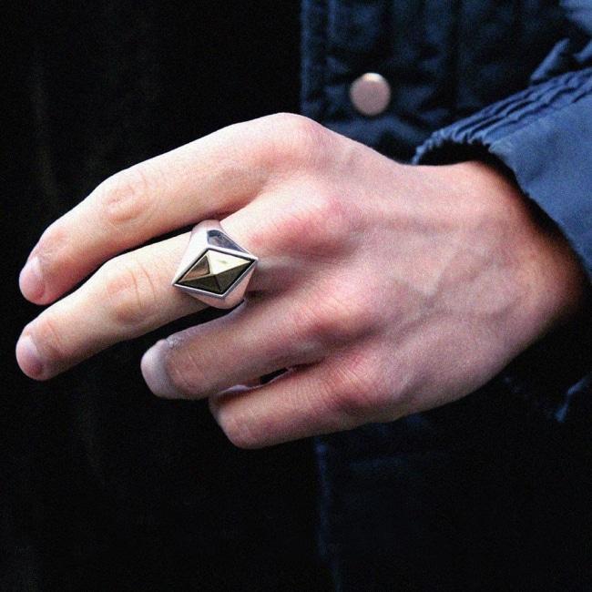 shot of a man in a blue jacket wearing the space god ring