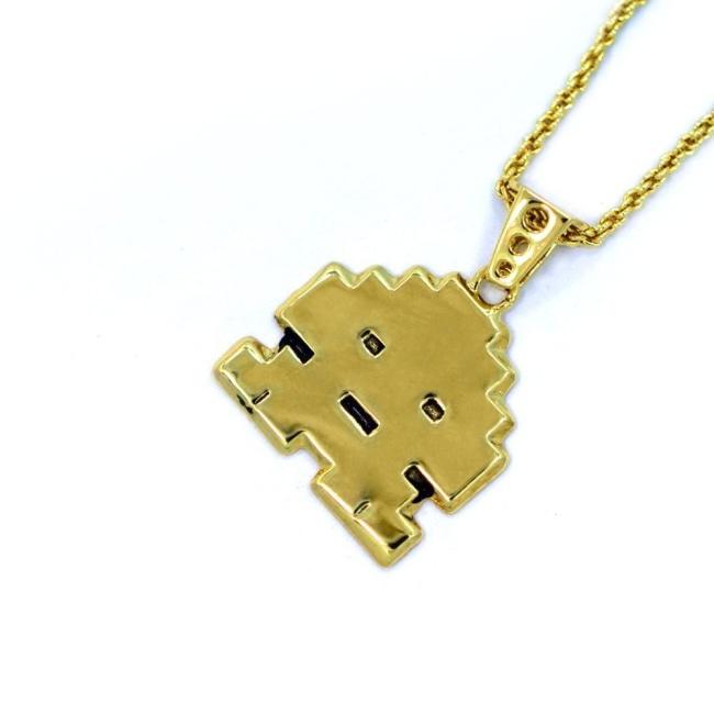 right angled view of the Stoney invader pendant in gold on a white background