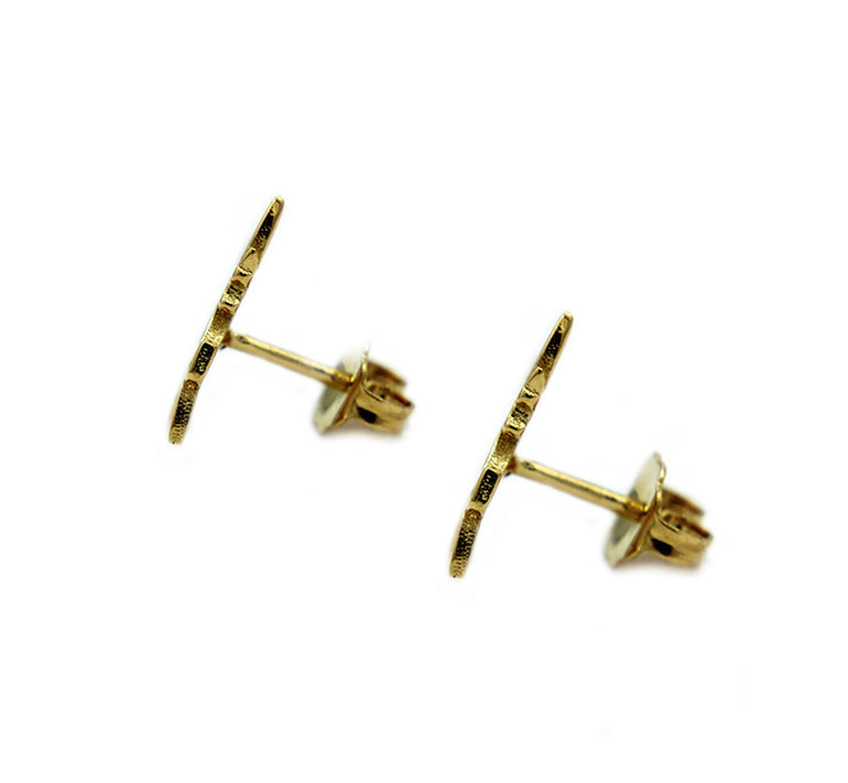 side view of the swiftwind studs in gold facing left casting a shadow