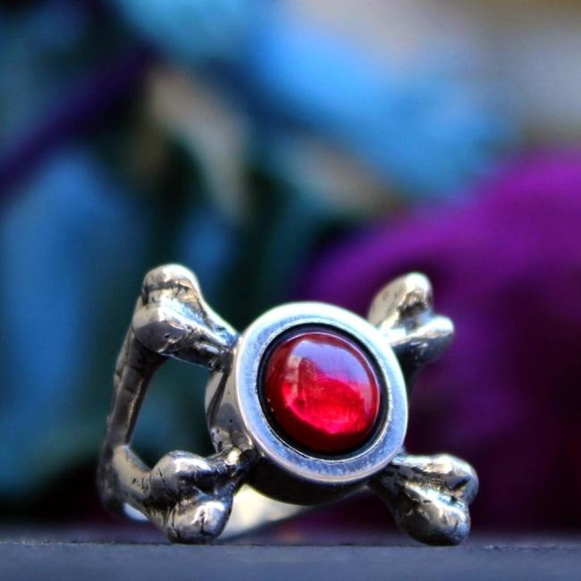 shot of the Skeletor armor Ring on a black stone with a skeletor toy in the background