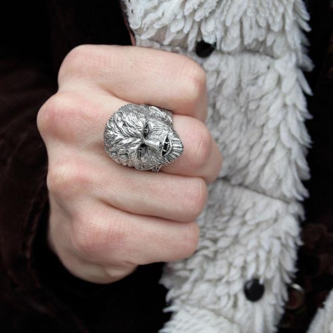 shot of a man wearing a black jacket with white fur wearing the wolfman ring
