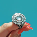 shot of a woman holding up a ufo ring in the sky