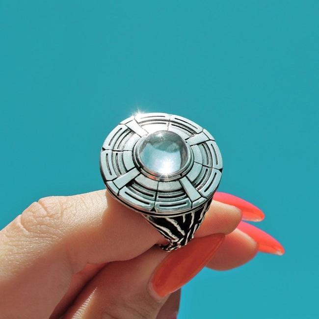 shot of a woman holding up a ufo ring in the sky