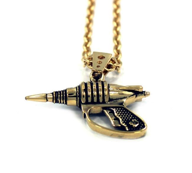 up close shot of the Zap pendant in gold on a white surface