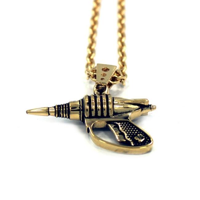 up close shot of the Zap pendant in gold on a white surface