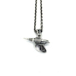 front view of the Zap pendant in silver on a white surface