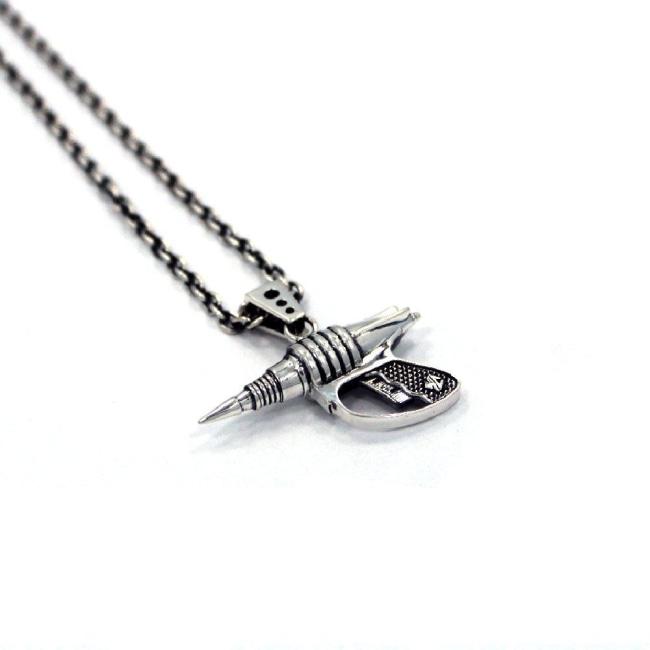 left side shot of the Zap pendant in silver on a white surface