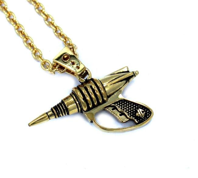 up close right side shot of the Zap pendant in gold on a white surface