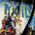 shot fo the zap pendant in gold on a person wearing an iron maiden band t shirt